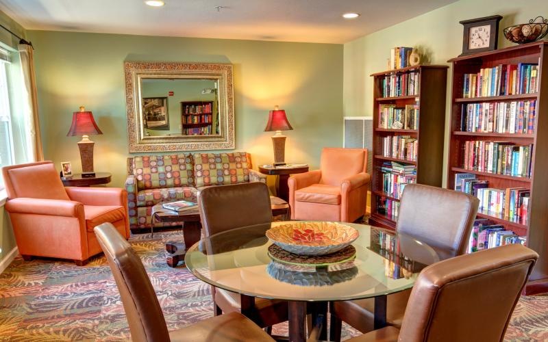 a living room with a table and chairs